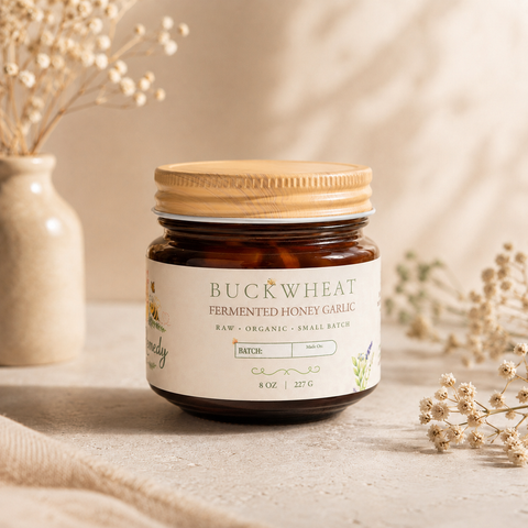 Jar of buckwheat fermented honey garlic on a neutral background with decorative elements.